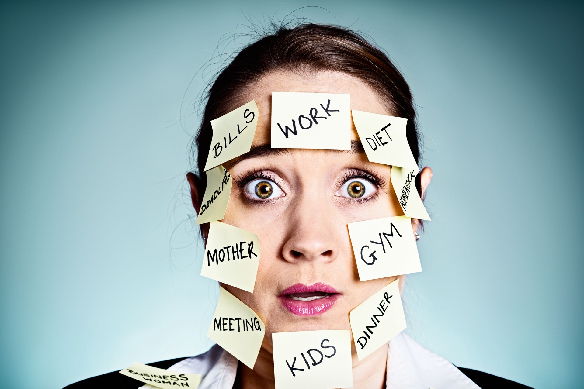 Shocked-looking woman multitasker covered in chores on sticky labels